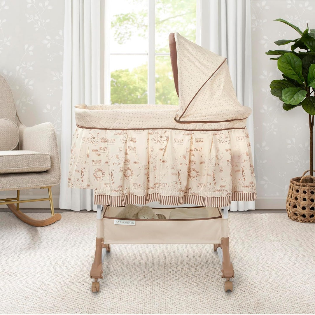 Delta Children Rocking Bedside Bassinet - Portable Crib with Lights Sounds and Vibrations, Play Time Jungle